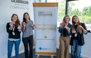 Participantes de la Semana de la Seguridad de L’Oréal frente al banner Safe Work Safe Home.